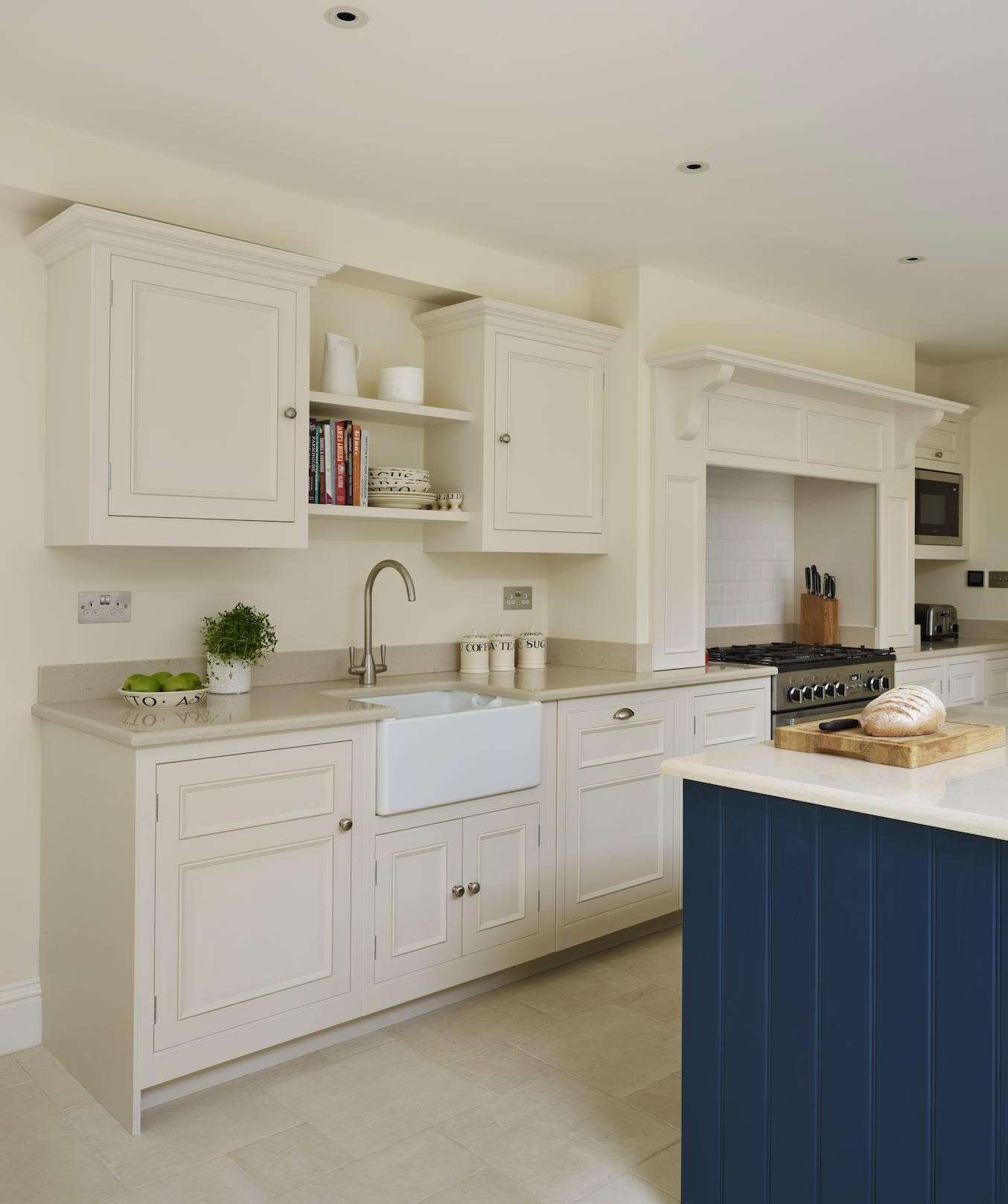 Cream kitchen cabinetry with white sink and silver tap