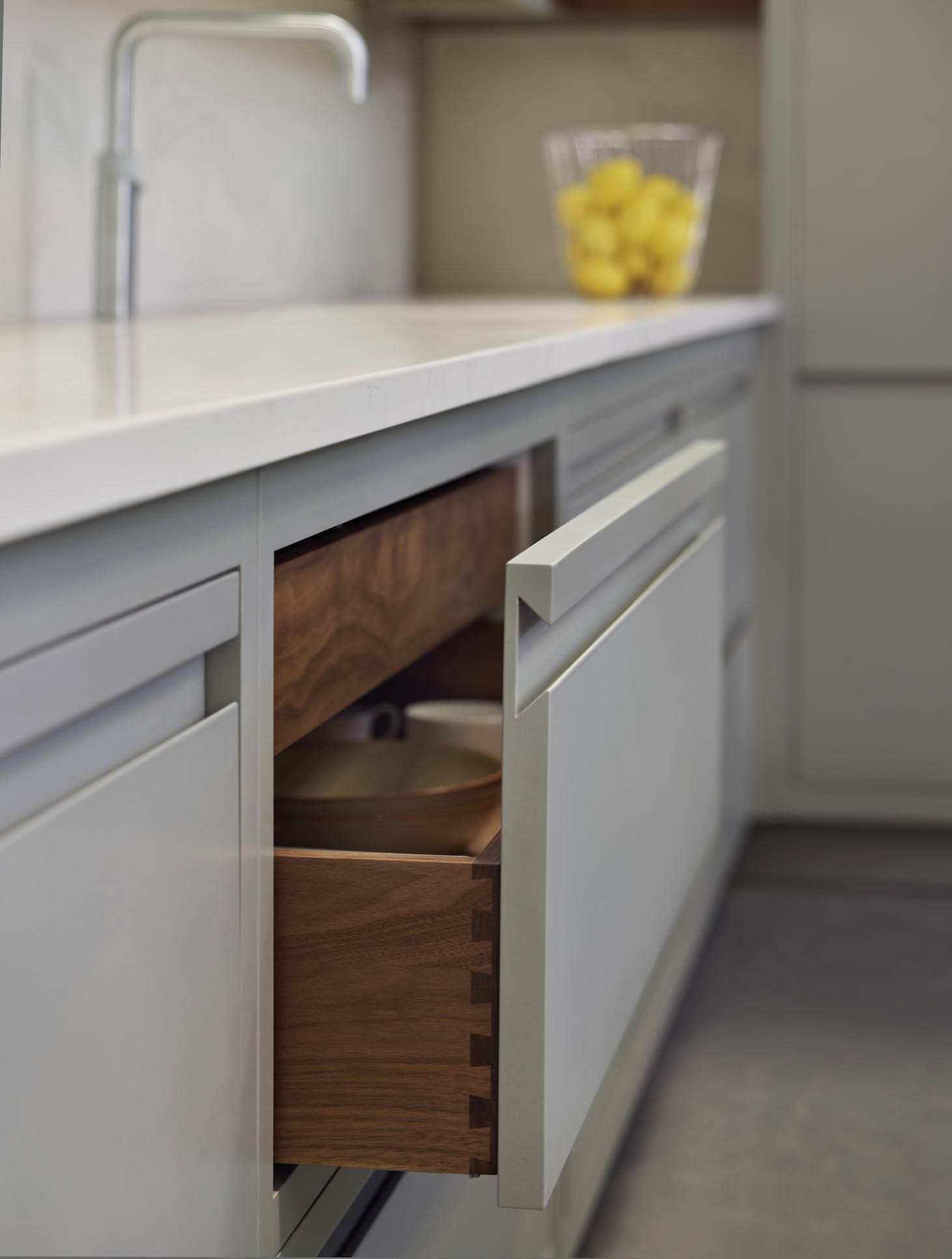 Green-grey Linear Edge kitchen drawer open to reveal dark oak lining