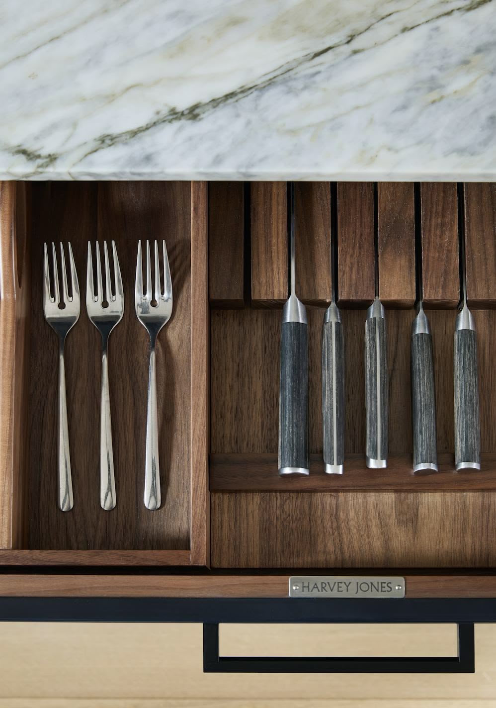 Black kitchen drawer with walnut interior open to show organised cutlery storage