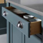 Close up of rich blue kitchen draw with silver handles