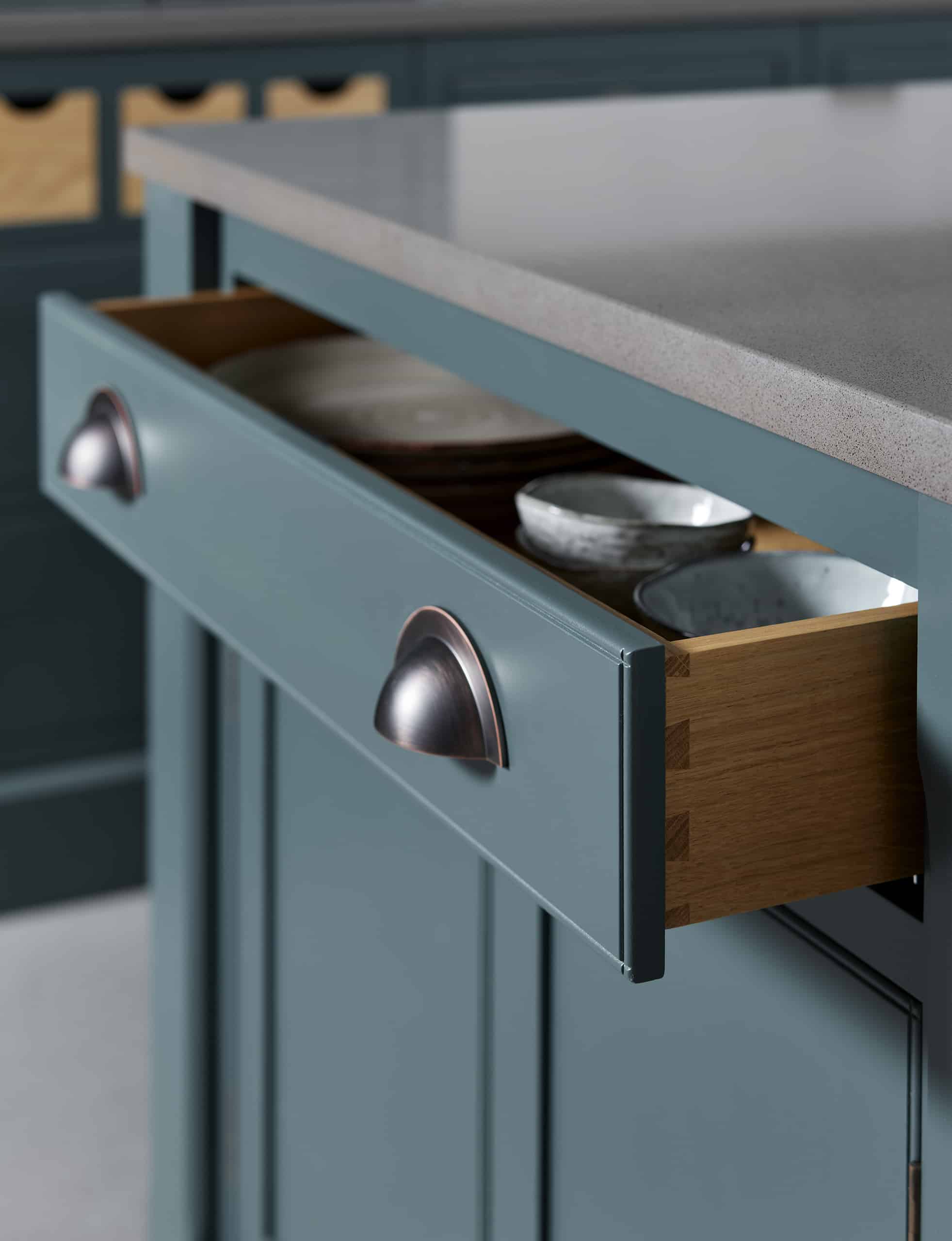 Close up of rich blue kitchen draw with silver handles