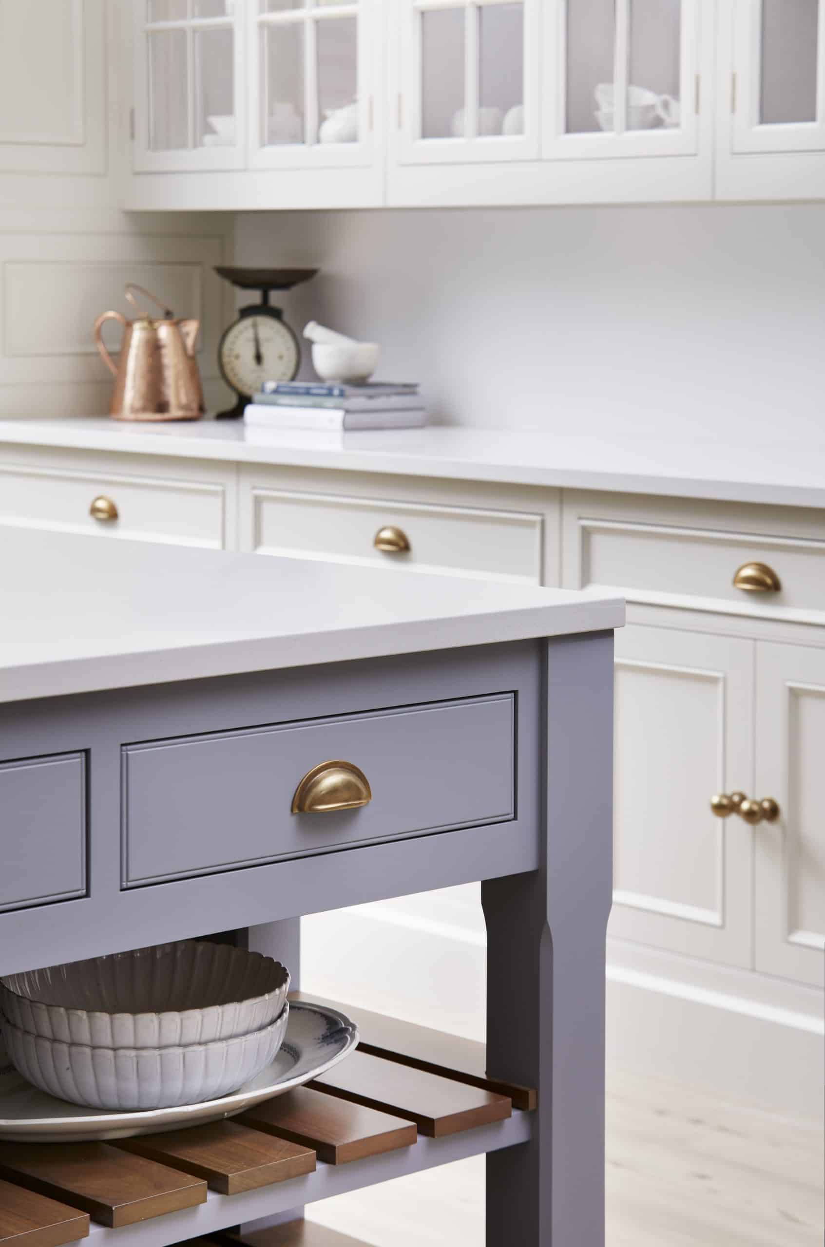 Closeup of blue kitchen island draw with brass handle