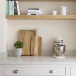 Closeup of white Arbor kitchen draws with silver handles and grey marble worktop