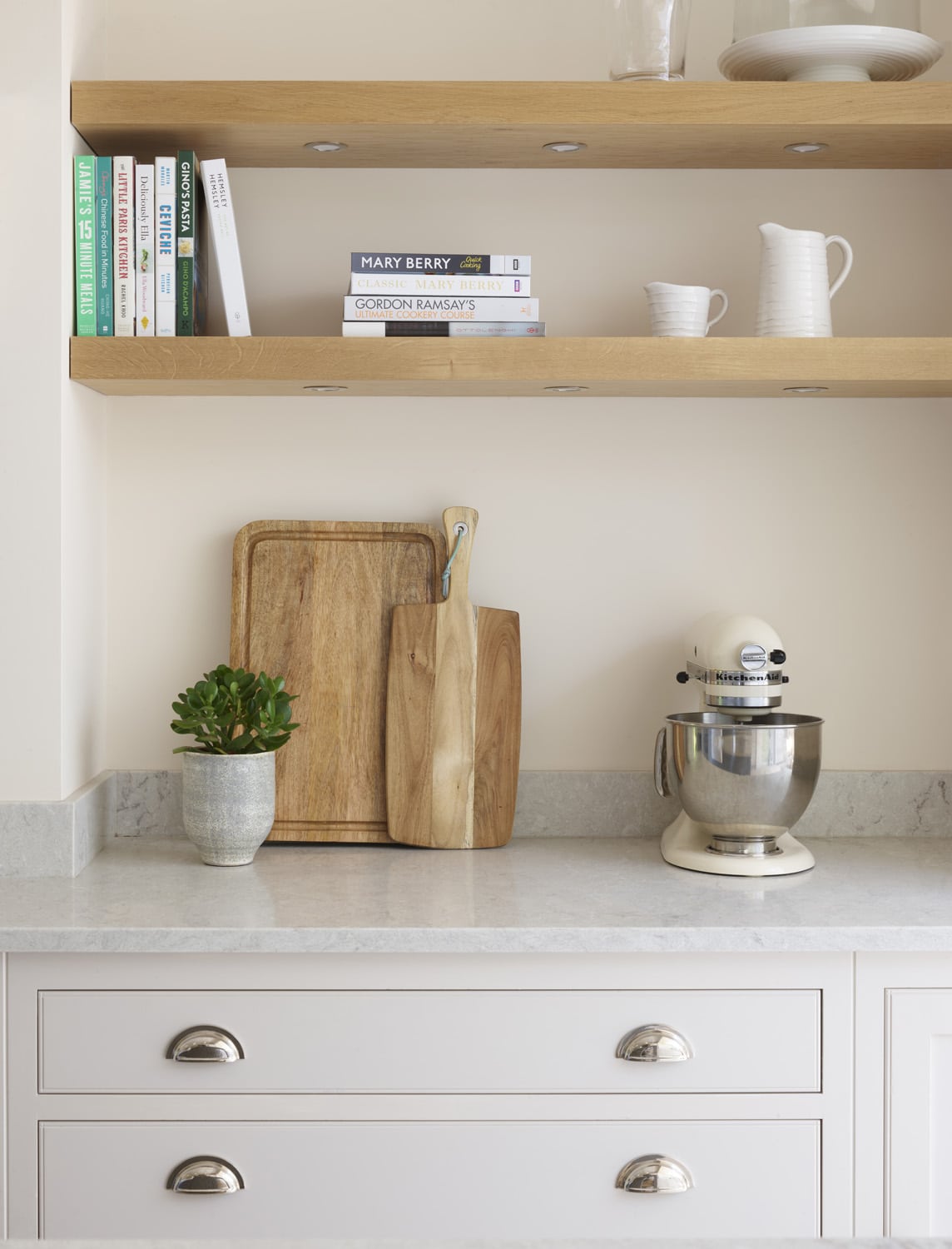 Closeup of white Arbor kitchen draws with silver handles and grey marble worktop