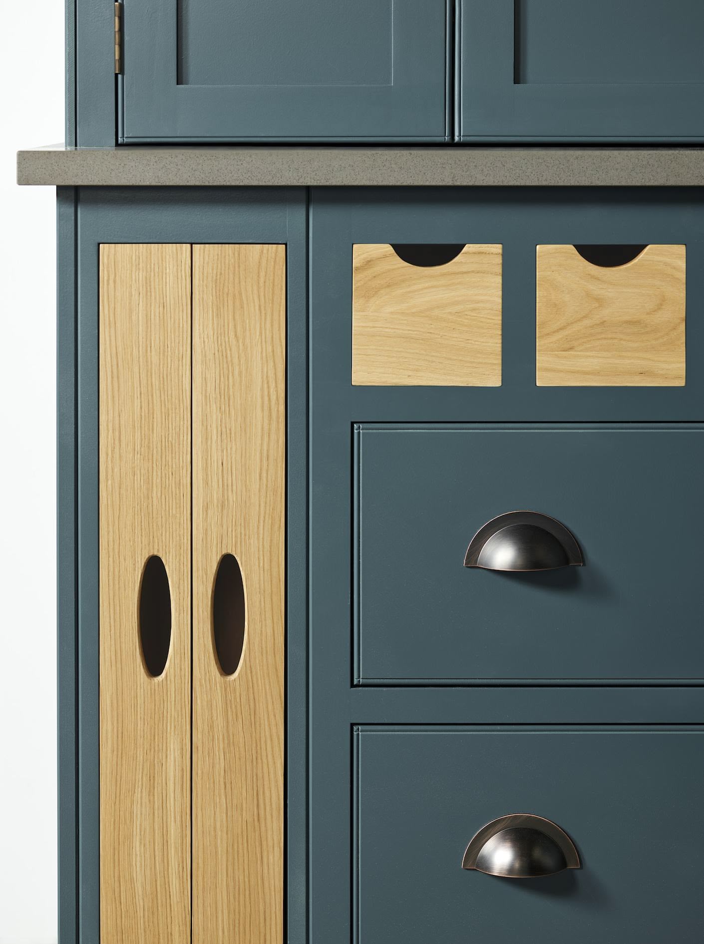 Close up of rich blue and natural wood kitchen draws