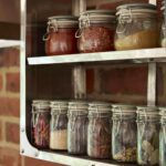 Closeup of organised shelving against an exposed brick wall