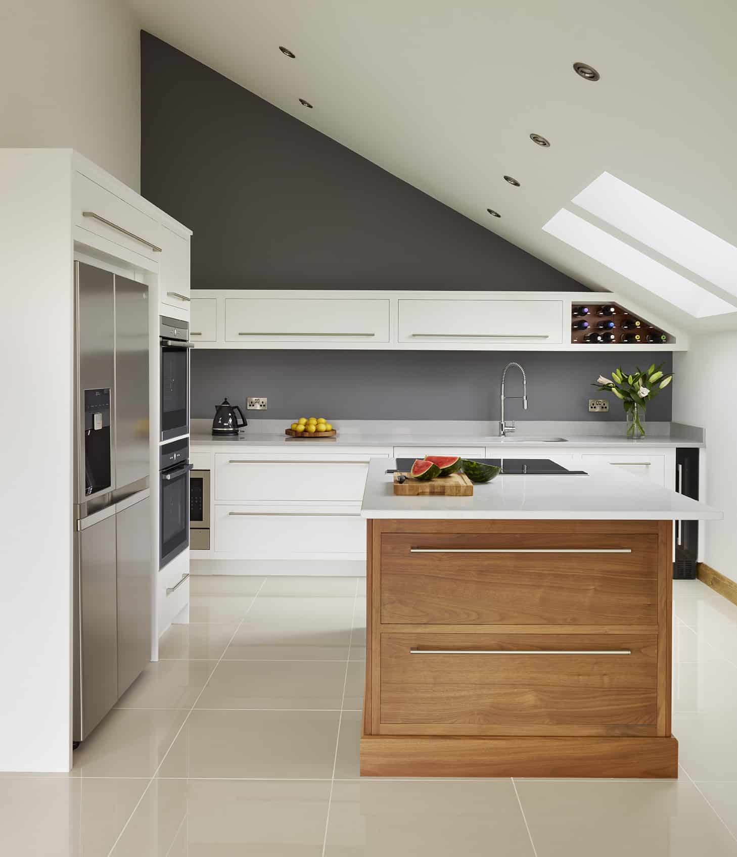 Walnut kitchen island surrounded by white Linear kitchen cabinetry