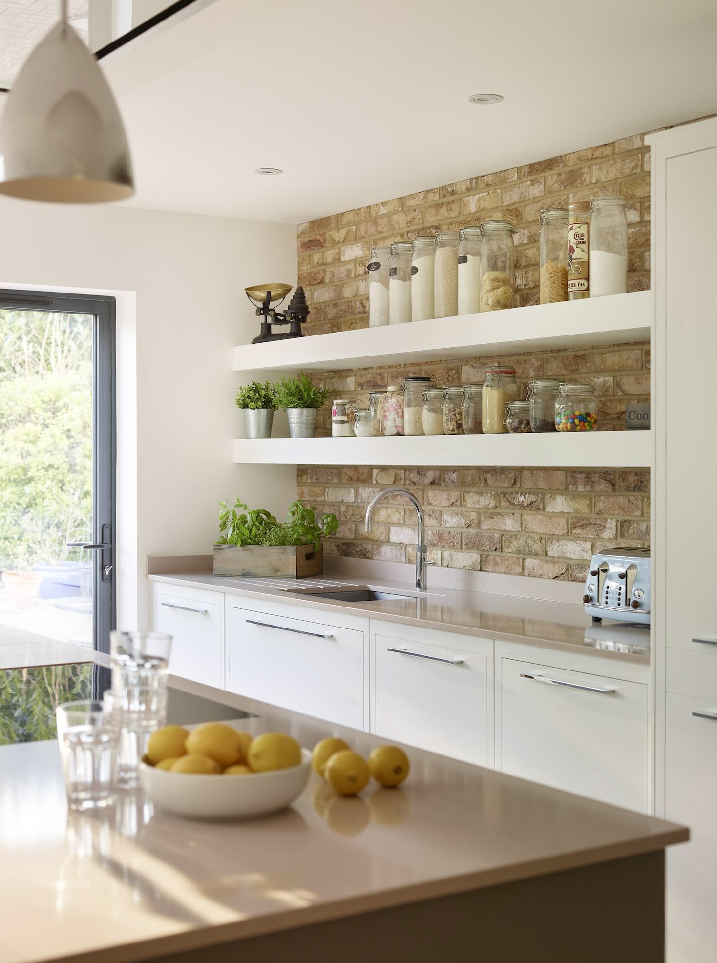 Linear Edge kitchen design featuring exposed brick wall