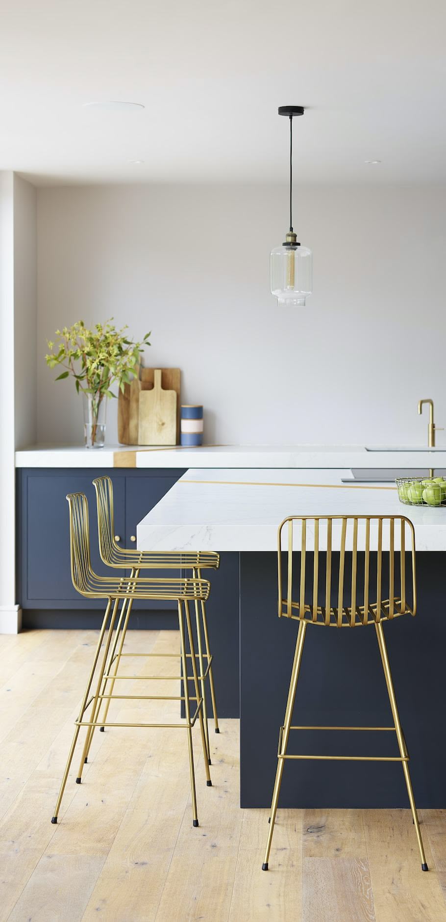 Harvey Jones Linear blue kitchen island with white worktop featuring gold barstools