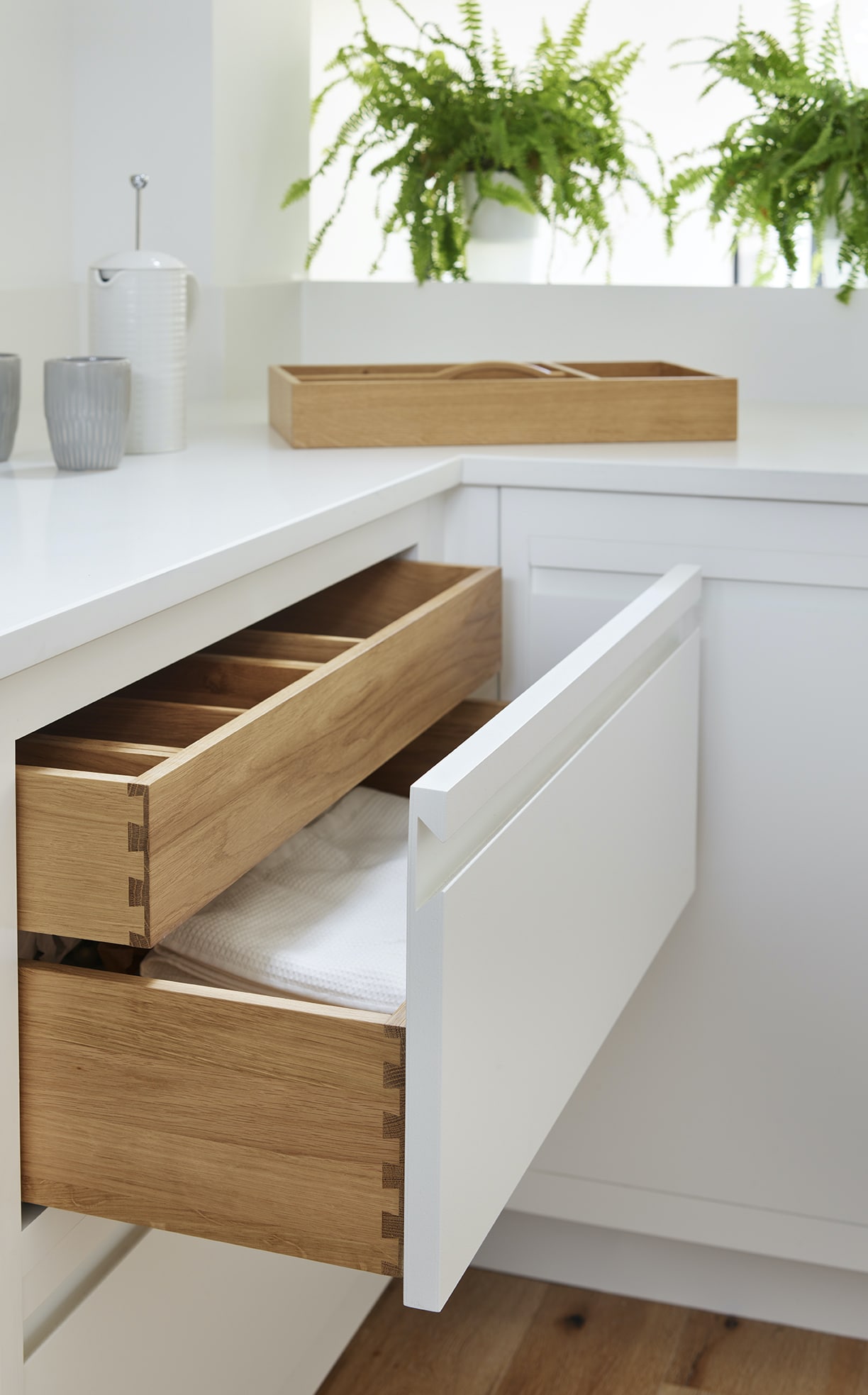 Harvey Jones Linear Edge design shown by white draws below a white worktop