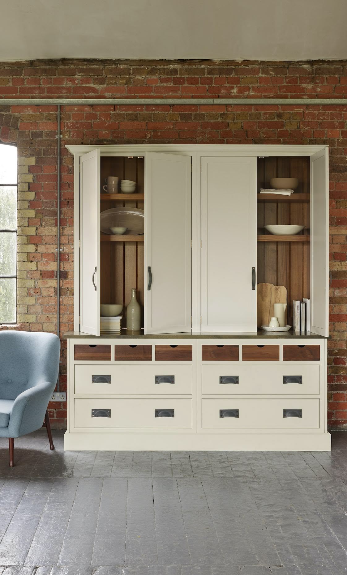 Cream kitchen pantry unit open to show organised storage