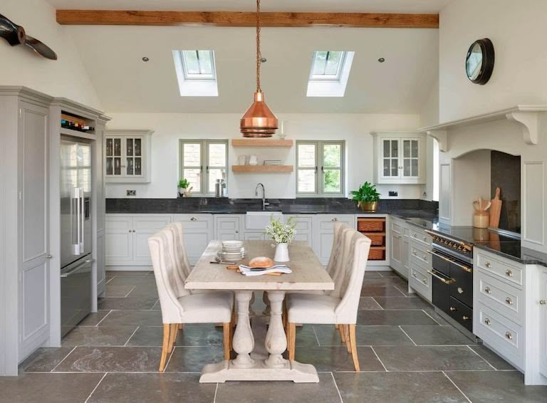 Harvey Jones open plan kitchen with white kitchen cabinetry and open plan dining area
