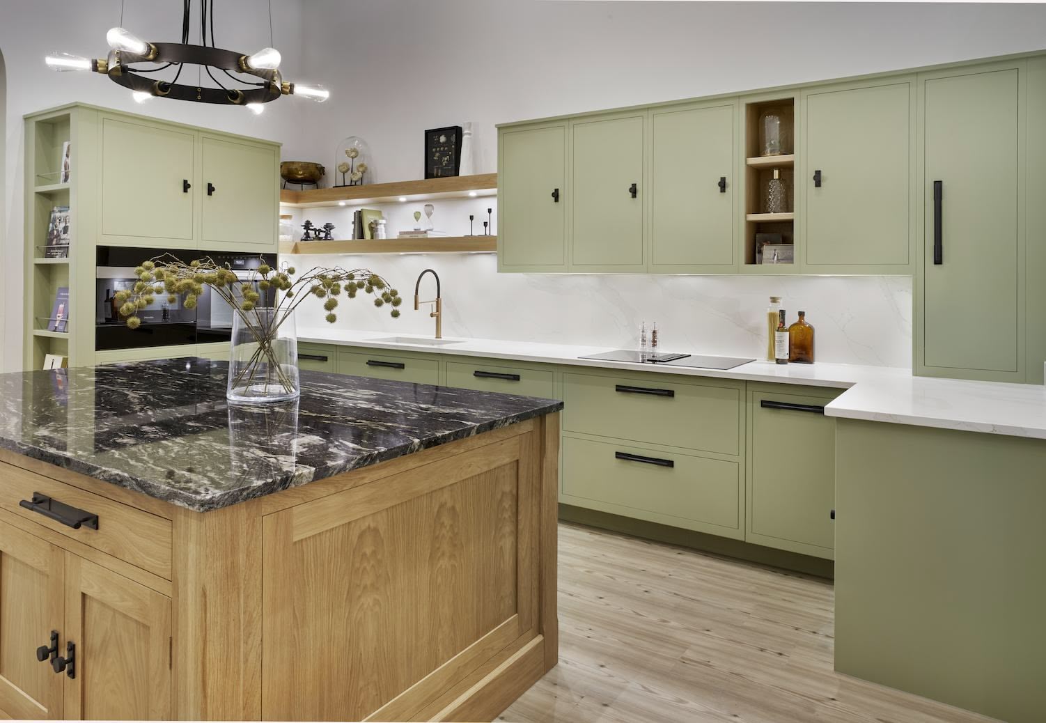 Green Linear Kitchen display featuring natural wooden kitchen island with black marble worktop