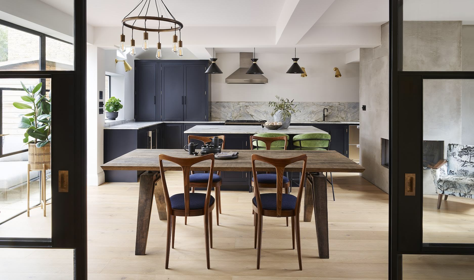 Dark Arbor kitchen cabinetry and kitchen dining area viewed from open doors
