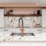 White Arbor kitchen cabinetry with white and pink marble worktops against pale pink walls