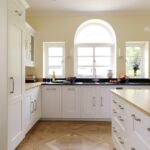 White Shaker kitchen cabinetry with oak worktops