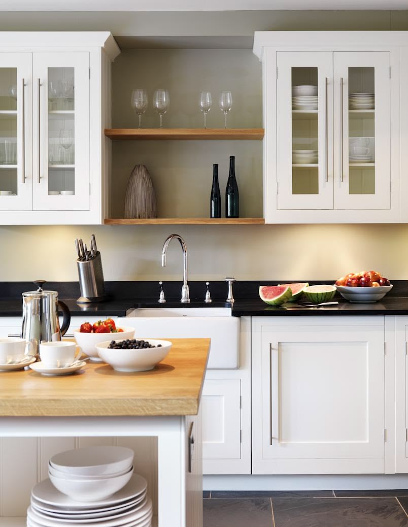 White Shaker kitchen cabinetry with black worktops