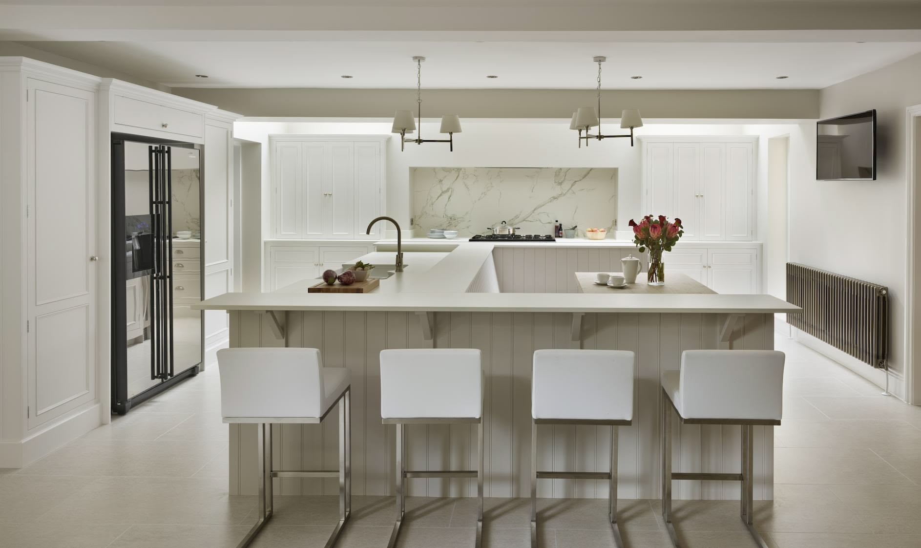 White stools against a white breakfast bar