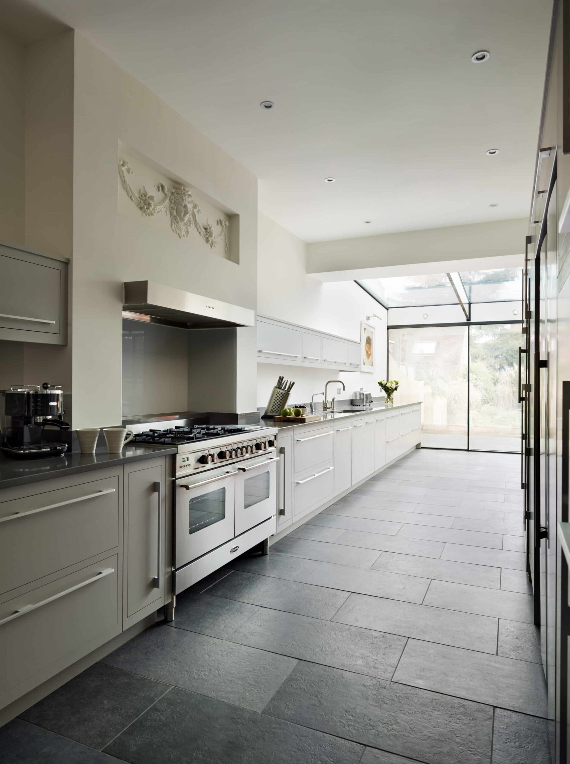 Long Linear kitchen featuring grey cabinetry and black worktops