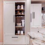 White Arbor kitchen storage with oak interior lining and organised shelving