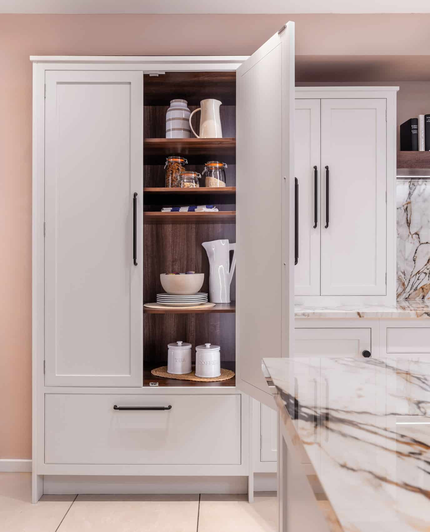 White Arbor kitchen storage with oak interior lining and organised shelving