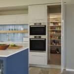 Secret pantry door open to reveal organised storage