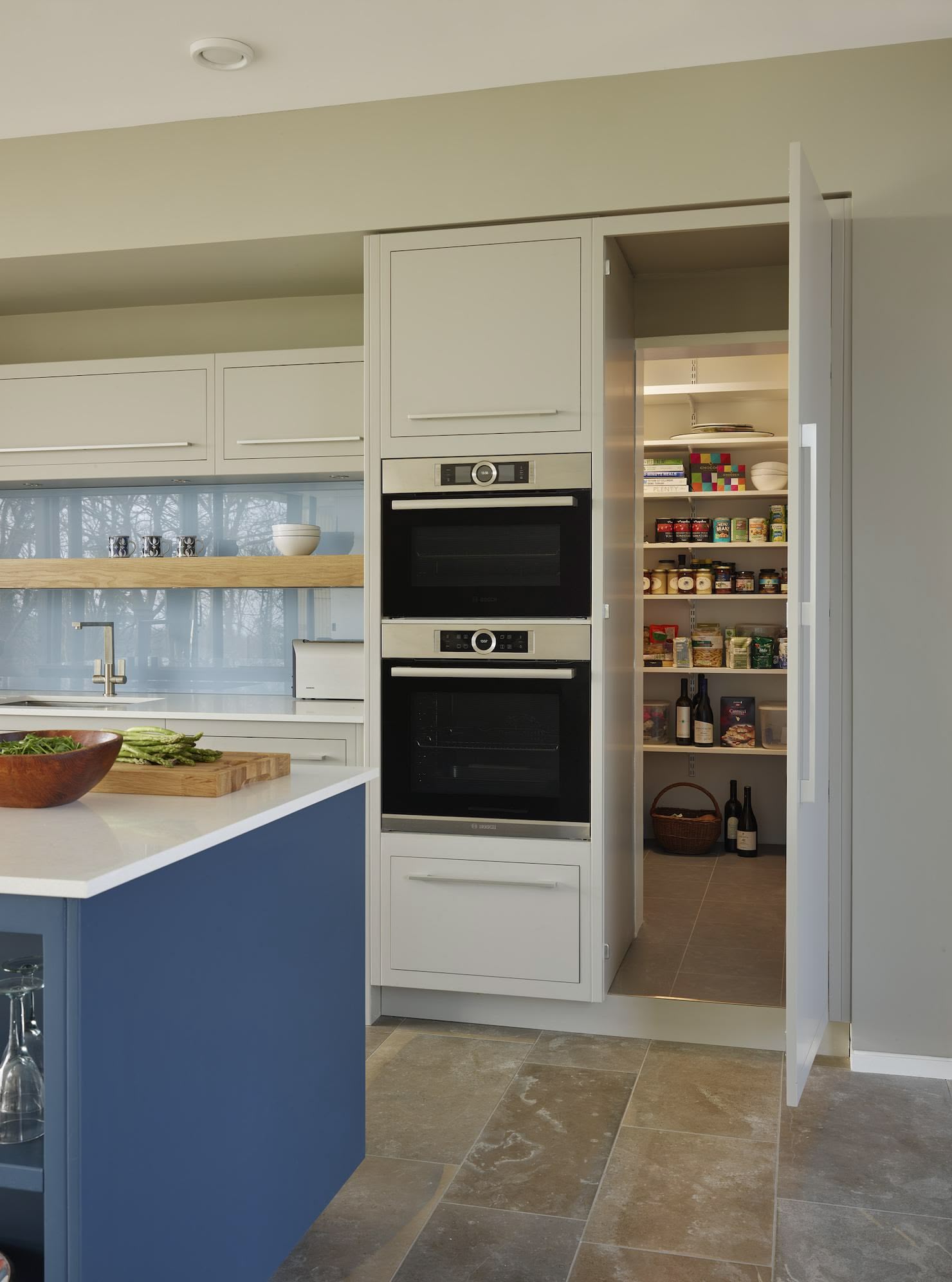 Secret pantry door open to reveal organised storage