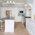 White Shaker kitchen cabinetry against pale blue walls