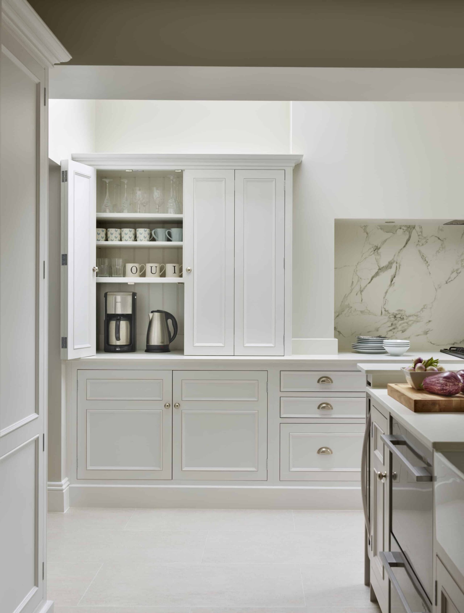 White Original kitchen cabinetry open to show organised storage