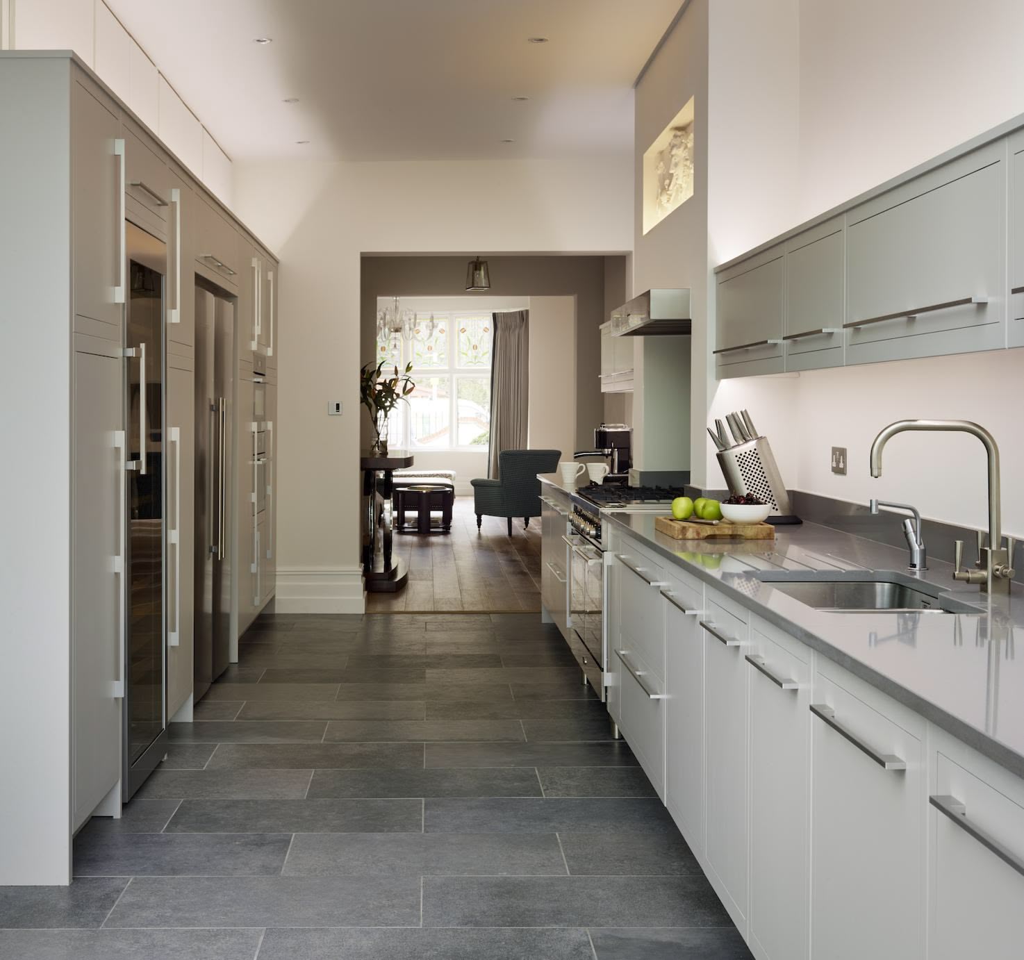 Long Linear kitchen featuring grey cabinetry and black worktops