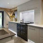 Grey Linear kitchen cabinetry with traditional style oven