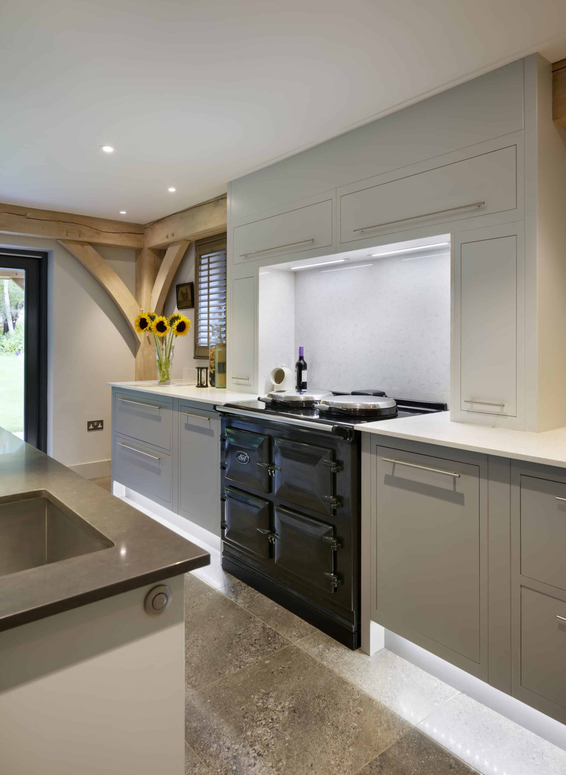 Grey Linear kitchen cabinetry with traditional style oven