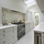 White Original kitchen cabinetry with marble splashback against the cooker