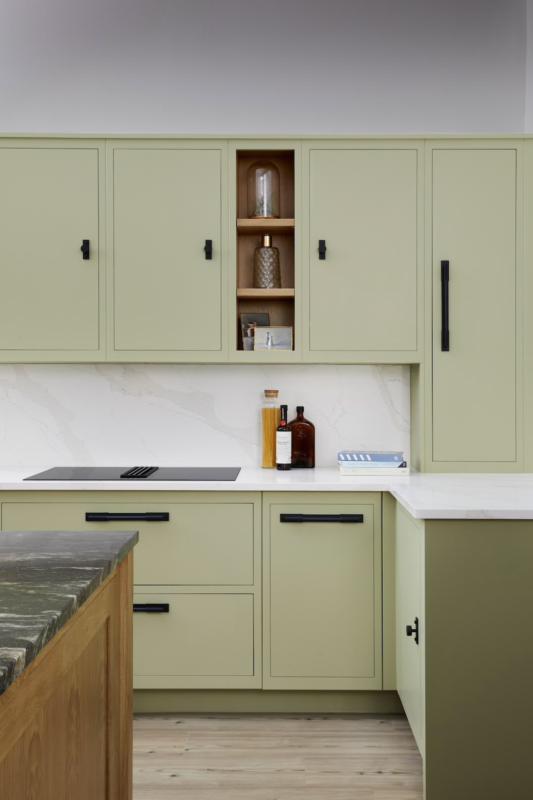 Green Linear kitchen cabinetry with black handles