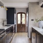 Dark Arbor kitchen cabinetry with white marble worktops and splashback