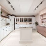 White and pink Arbor kitchen cabinetry with white and pink marble worktops against pale pink walls