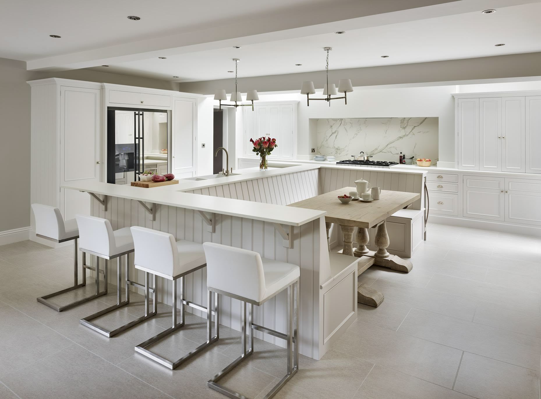 White Shaker kitchen cabinetry with dining nook