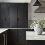Dark Arbor kitchen cabinetry with white marble worktops and splashback