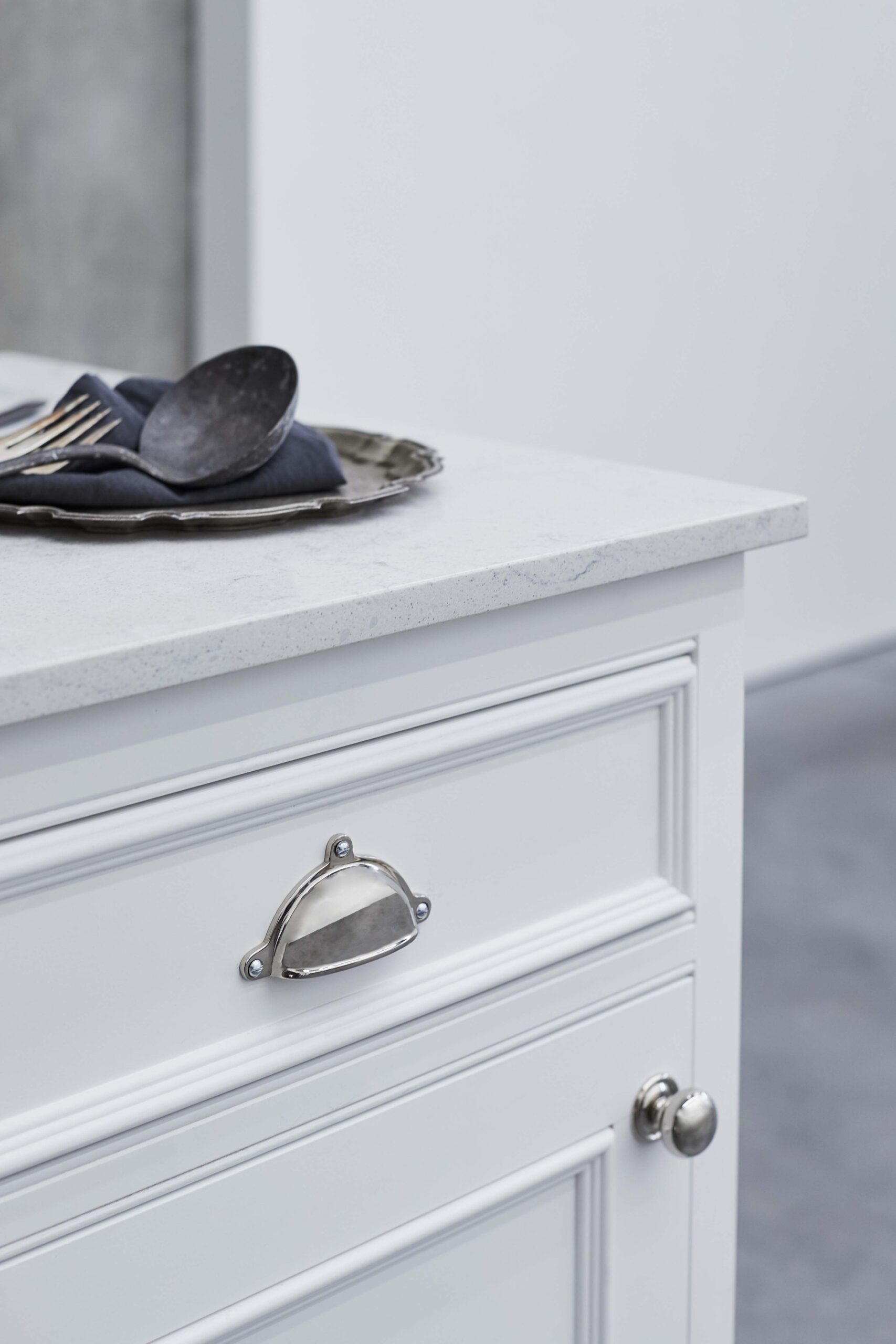 Closeup of white kitchen cabinetry with silver handle
