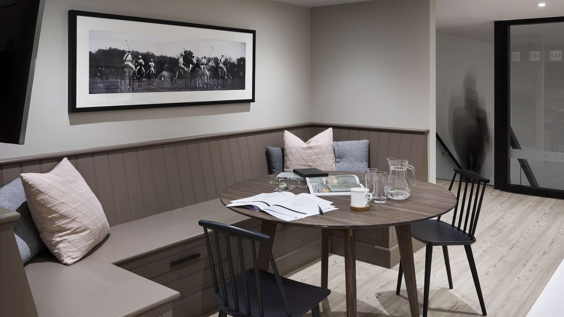 Dining area with brown bench seating against dark wood dining table