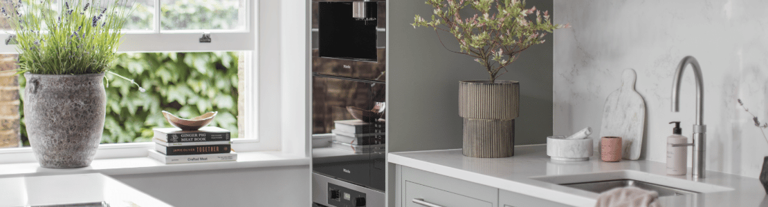 Harvey Jones kitchen featuring grey kitchen cabinetry with white worktops