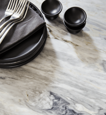 Closeup of white marble worktop with dinnerware
