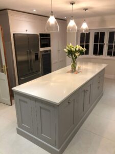 Grey kitchen island with white worktop