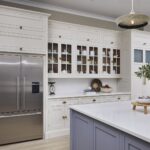Cream Original design kitchen featuring white cabinetry with framed glass doors
