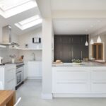 Bright Linear kitchen design featuring white kitchen cabinetry
