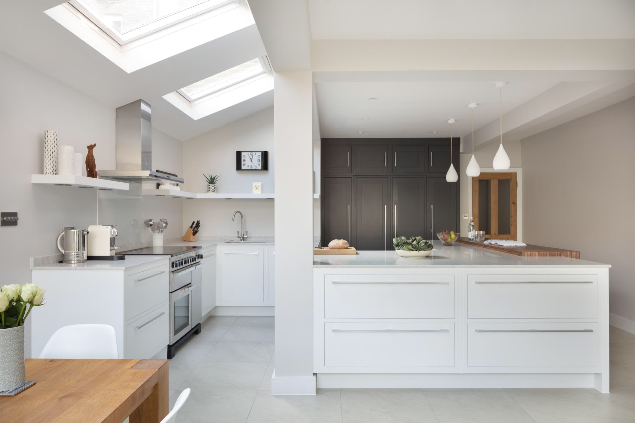 Bright Linear kitchen design featuring white kitchen cabinetry