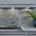 Grey-green marble worktop and splashback featuring integrated hob