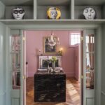 Pink Original Kitchen design seen from green entrance surrounded by display shelving
