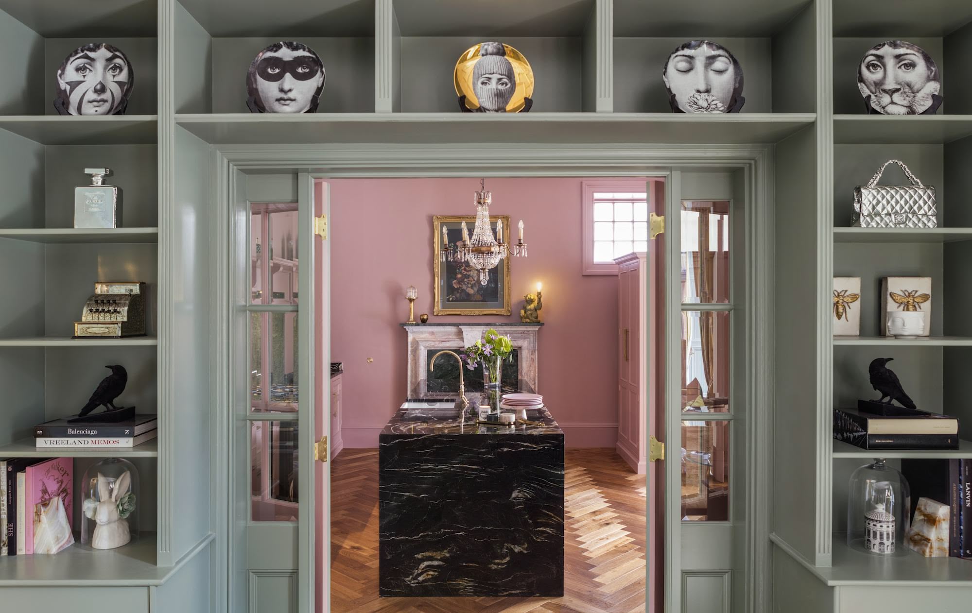 Pink Original Kitchen design seen from green entrance surrounded by display shelving