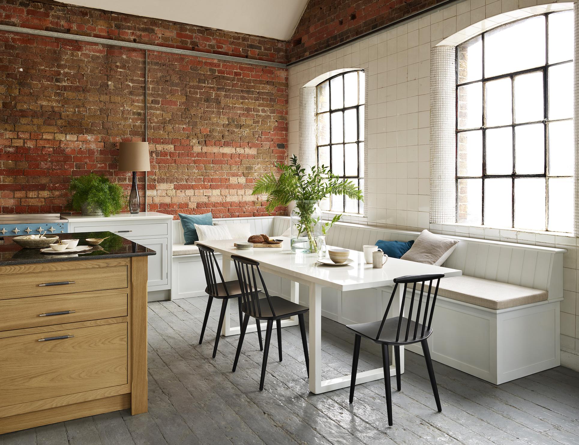 Open plan kitchen dining area featuring white banquette seating
